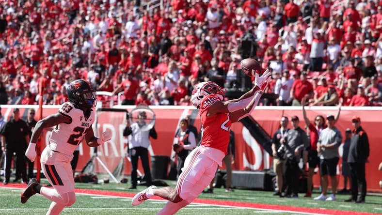 Oct 1, 2022; Salt Lake City, Utah, USA; Utah Utes wide receiver Jaylen Dixon (25) catches a touchdown pass against Oregon State Beavers linebacker Cade Brownholtz (29) in the first quarter at Rice-Eccles Stadium. Mandatory Credit: Rob Gray-USA TODAY Sports