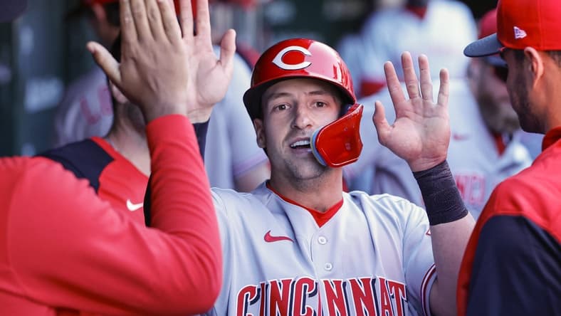 Oct 1, 2022; Chicago, Illinois, USA; Cincinnati Reds first baseman Spencer Steer (12) celebrates with teammates after scoring against the Chicago Cubs during the third inning at Wrigley Field. Mandatory Credit: Kamil Krzaczynski-USA TODAY Sports