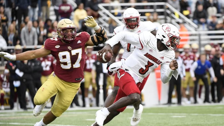 Oct 1, 2022; Chestnut Hill, Massachusetts, USA;  Louisville Cardinals quarterback Malik Cunningham (3) runs from Boston College Eagles defensive end Marcus Valdez (97) during the first half at Alumni Stadium. Mandatory Credit: Bob DeChiara-USA TODAY Sports