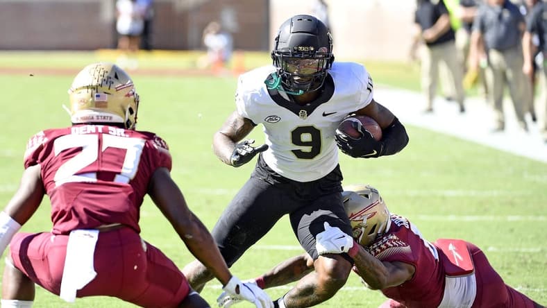 Oct 1, 2022; Tallahassee, Florida, USA; Wake Forest Demon Deacons wide receiver AT Perry (9) is tackled by Florida State Seminoles defensive back Renardo Green (8) during the first half at Doak S. Campbell Stadium. Mandatory Credit: Melina Myers-USA TODAY Sports