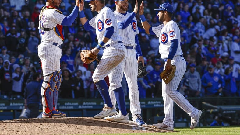 Oct 1, 2022; Chicago, Illinois, USA; Chicago Cubs players celebrate the win against the Cincinnati Reds at Wrigley Field. Mandatory Credit: Kamil Krzaczynski-USA TODAY Sports