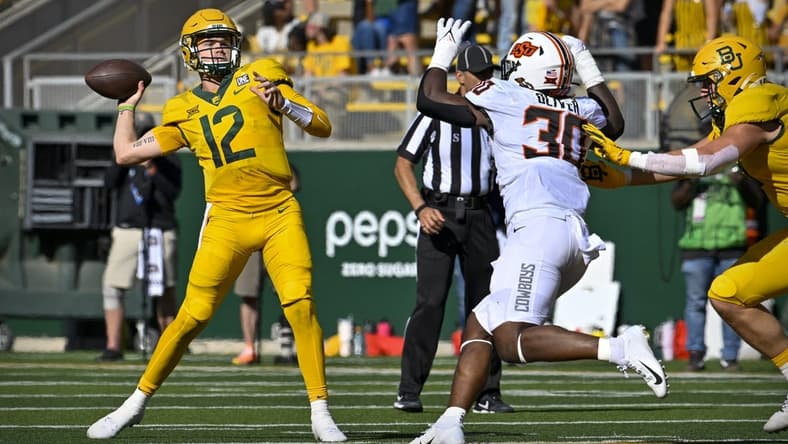 Oct 1, 2022; Waco, Texas, USA; Baylor Bears quarterback Blake Shapen (12) throws a pass for a touchdown to wide receiver Monaray Baldwin (not pictured) as Oklahoma State Cowboys defensive end Collin Oliver (30) defends during the second half at McLane Stadium. Mandatory Credit: Jerome Miron-USA TODAY Sports