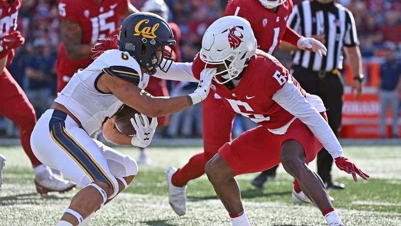 Oct 1, 2022; Pullman, Washington, USA; California Golden Bears running back Jaydn Ott, left, tries to stiff arm Washington State Cougars defensive back Chau Smith-Wade (6) in the first half at Gesa Field at Martin Stadium. Mandatory Credit: James Snook-USA TODAY Sports