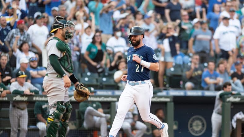 Oct 1, 2022; Seattle, Washington, USA; Seattle Mariners left fielder Jesse Winker (27) scores a run off a single hit by Seattle Mariners catcher Luis Torrens (22) (not pictured) during the eighth inning at T-Mobile Park. Mandatory Credit: Steven Bisig-USA TODAY Sports