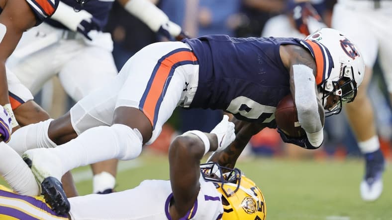 Oct 1, 2022; Auburn, Alabama, USA;  Auburn Tigers cornerback Keionte Scott (6) is tackled by LSU Tigers cornerback Sevyn Banks (1) during the first quarter at Jordan-Hare Stadium. Mandatory Credit: John Reed-USA TODAY Sports