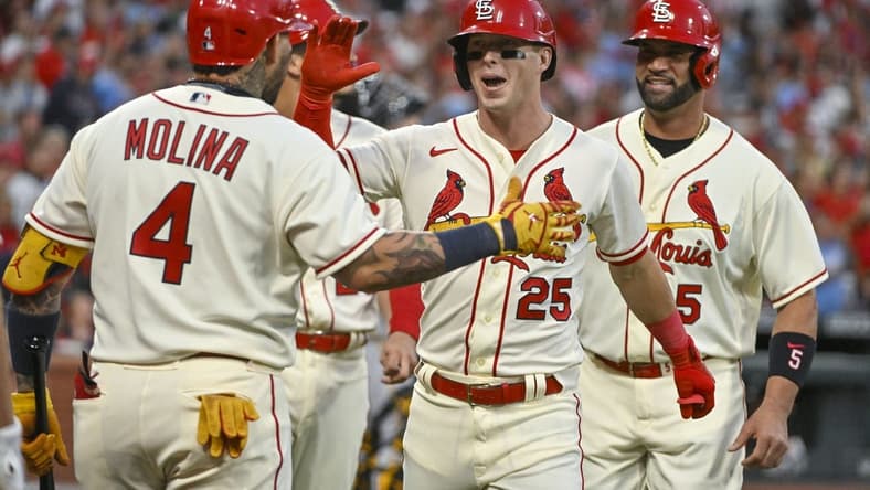 Oct 1, 2022; St. Louis, Missouri, USA;  St. Louis Cardinals left fielder Corey Dickerson (25) celebrates with catcher Yadier Molina (4) after hitting a grand slam home run against the Pittsburgh Pirates during the first inning at Busch Stadium. Mandatory Credit: Jeff Curry-USA TODAY Sports