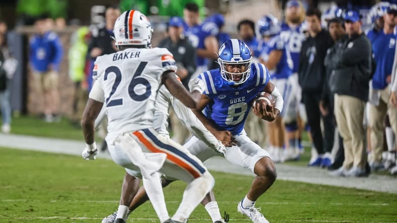 Oct 1, 2022; Durham, North Carolina, USA; Duke Blue Devils quarterback Jordan Moore (8) runs with the ball against Virginia Cavaliers Jaylon Baker cornerback (26) during the first half at Wallace Wade Stadium. Mandatory Credit: Jaylynn Nash-USA TODAY Sports