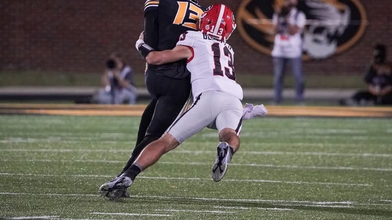 Oct 1, 2022; Columbia, Missouri, USA; Missouri Tigers defensive back Daylan Carnell (13) is tackled by Georgia Bulldogs quarterback Stetson Bennett (13) after Carnell s interception during the first half at Faurot Field at Memorial Stadium. Mandatory Credit: Denny Medley-USA TODAY Sports