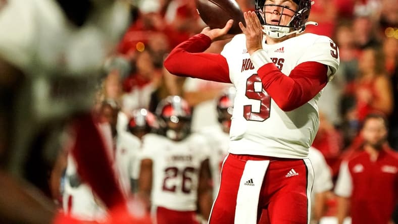 Oct 1, 2022; Lincoln, Nebraska, USA; Indiana Hoosiers quarterback Connor Bazelak (9) throws a touchdown pass during the second quarter  against the Nebraska Cornhuskers at Memorial Stadium. Mandatory Credit: Dylan Widger-USA TODAY Sports