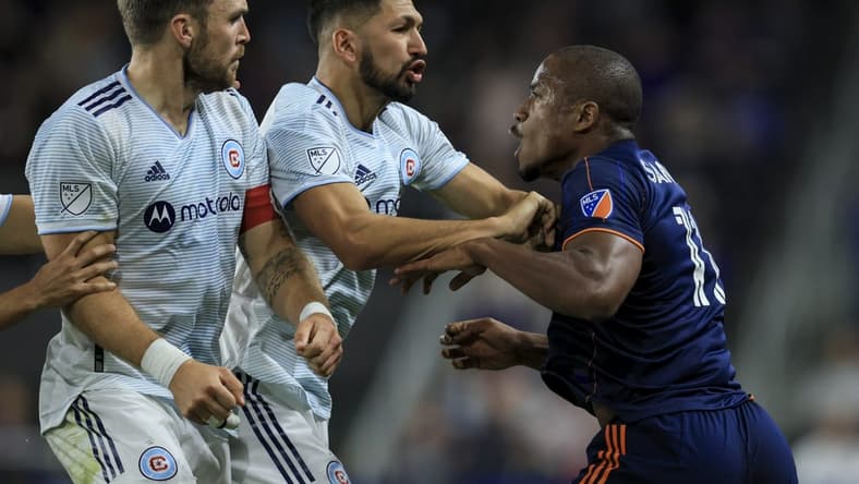 Oct 1, 2022; Cincinnati, Ohio, USA;  FC Cincinnati forward Sergio Santos (right) scrums with Chicago Fire defender Rafael Czichos (left) and defender Mauricio Pineda (middle) in the second half at TQL Stadium. Mandatory Credit: Aaron Doster-USA TODAY Sports