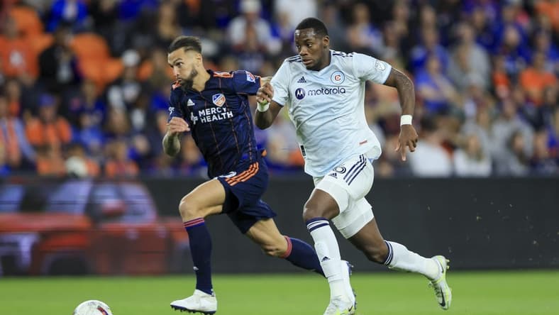 Oct 1, 2022; Cincinnati, Ohio, USA;  FC Cincinnati defender Geoff Cameron (left) chase as Chicago Fire forward Jhon Duran (26) controls the ball in the second half at TQL Stadium. Mandatory Credit: Aaron Doster-USA TODAY Sports