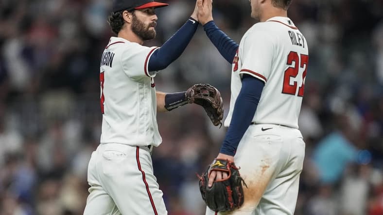 Oct 1, 2022; Cumberland, Georgia, USA; Atlanta Braves shortstop Dansby Swanson (7) reacts with third baseman Austin Riley (27) after the Braves defeated the New York Mets at Truist Park. Mandatory Credit: Dale Zanine-USA TODAY Sports