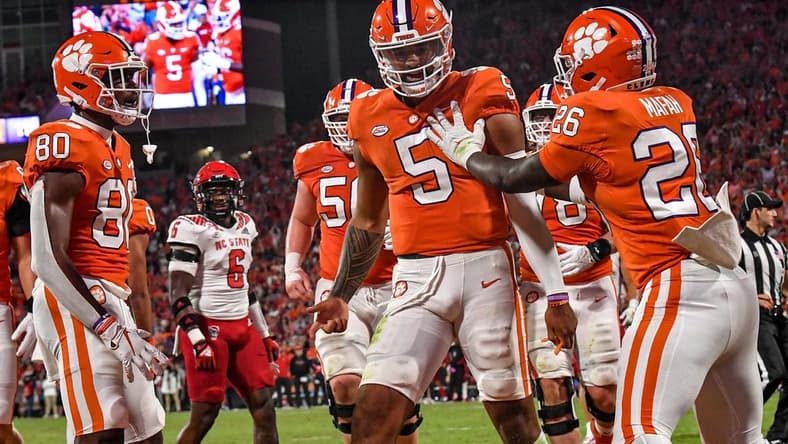 Oct 1, 2022; Clemson, South Carolina, USA; Clemson quarterback D.J. Uiagalelei (5) celebrates a score with running back Phil Mafah (26) against NC State on a one-yard touchdown run during the second quarter at Memorial Stadium. Mandatory Credit: Ken Ruinard-USA TODAY Sports