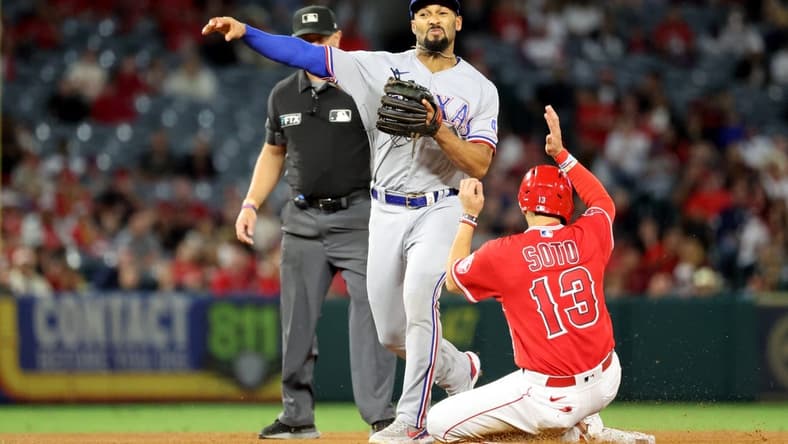 Oct 1, 2022; Anaheim, California, USA;  Texas Rangers second baseman Marcus Semien (2) forces out Los Angeles Angels third baseman Livan Soto (13) at second while attempting to complete a double play during the fifth inning at Angel Stadium. Mandatory Credit: Kiyoshi Mio-USA TODAY Sports