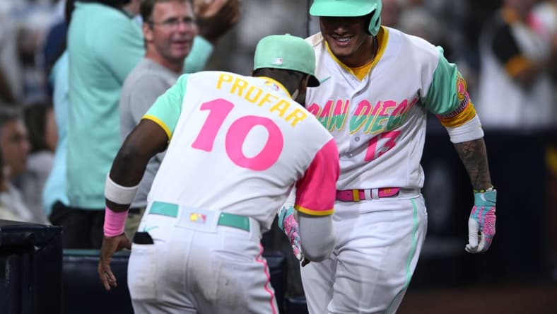 Oct 1, 2022; San Diego, California, USA; San Diego Padres third baseman Manny Machado (13) is congratulated by left fielder Jurickson Profar (10) after hitting a home run against the Chicago White Sox during the seventh inning at Petco Park. Mandatory Credit: Orlando Ramirez-USA TODAY Sports