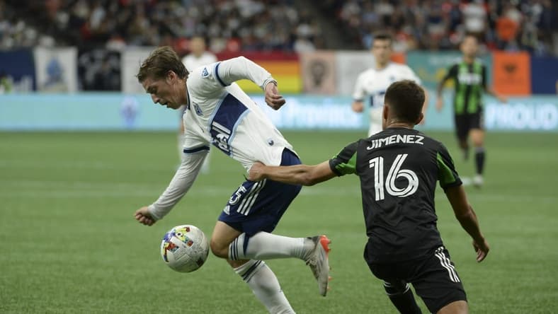 Oct 1, 2022; Vancouver, British Columbia, CAN;  Vancouver Whitecaps FC midfielder Ryan Gauld (25) takes possession of the ball against Austin FC midfielder Hector Jimenez (16) during the first half at BC Place. Mandatory Credit: Anne-Marie Sorvin-USA TODAY Sports
