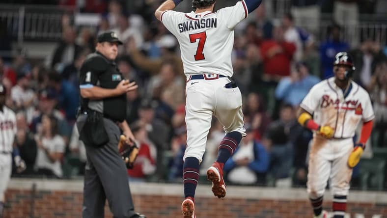 Oct 1, 2022; Cumberland, Georgia, USA; Atlanta Braves shortstop Dansby Swanson (7) reacts after hitting a home run against the New York Mets during the fifth inning at Truist Park. Mandatory Credit: Dale Zanine-USA TODAY Sports
