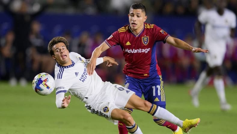 Oct 1, 2022; Carson, California, USA; LA Galaxy midfielder Ricard Puig (6) is fouled by Real Salt Lake forward Jefferson Savarino (11) during the first half at Dignity Health Sports Park. Mandatory Credit: Kelvin Kuo-USA TODAY Sports