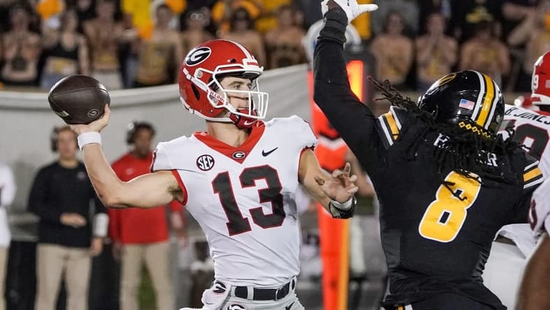 Oct 1, 2022; Columbia, Missouri, USA; Georgia Bulldogs quarterback Stetson Bennett (13) throws a pass as Missouri Tigers linebacker Ty'Ron Hopper (8) tries to block during the second half at Faurot Field at Memorial Stadium. Mandatory Credit: Denny Medley-USA TODAY Sports