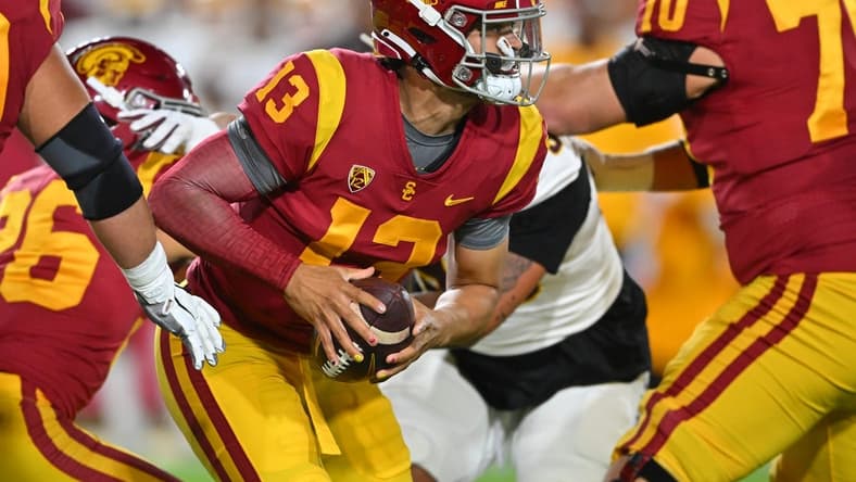 Oct 1, 2022; Los Angeles, California, USA;  USC Trojans quarterback Caleb Williams (13) recovers a fumbled snap and runs for a first down against the Arizona State Sun Devils in the first half at United Airlines Field at the Los Angeles Memorial Coliseum. Mandatory Credit: Jayne Kamin-Oncea-USA TODAY Sports