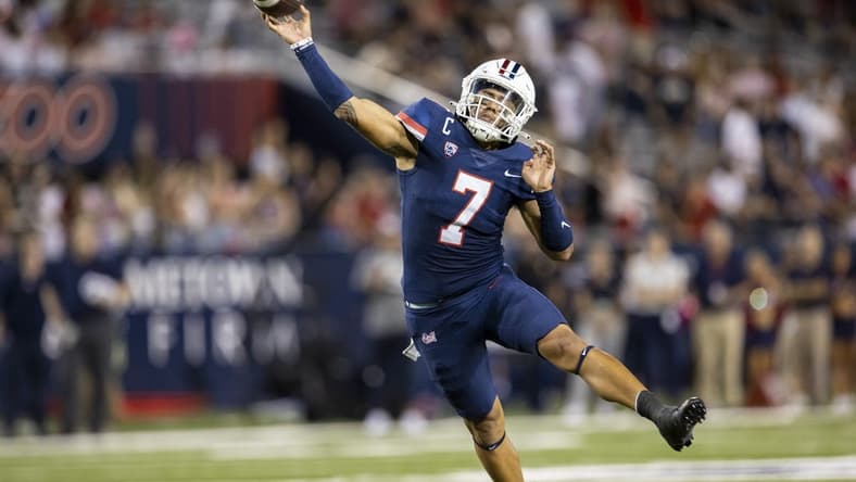 Oct 1, 2022; Tucson, Arizona, USA; Arizona Wildcats quarterback Jayden de Laura (7) throws a touchdown pass to wide receiver Tetairoa McMillan (not pictured) against the Colorado Buffaloes in the first half at Arizona Stadium. Mandatory Credit: Ivan Pierre Aguirre-USA TODAY Sports