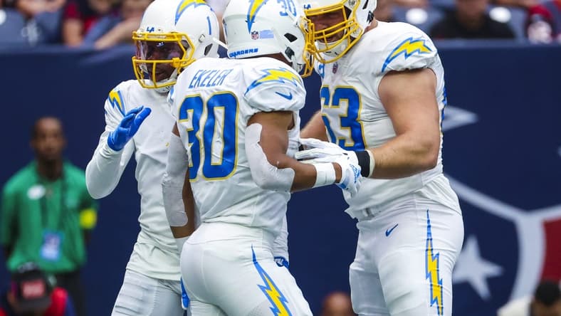Oct 2, 2022; Houston, Texas, USA; Los Angeles Chargers running back Austin Ekeler (30) celebrates with Los Angeles Chargers center Corey Linsley (63) after running for a touchdown during the second quarter against the Houston Texans at NRG Stadium. Mandatory Credit: Kevin Jairaj-USA TODAY Sports