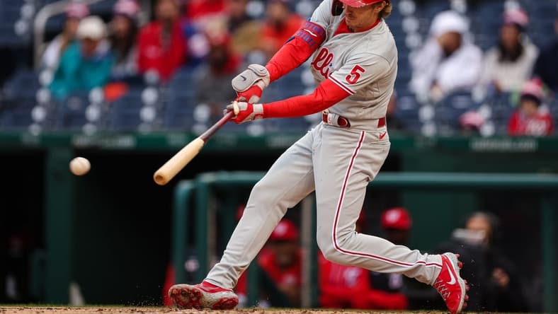 Oct 2, 2022; Washington, District of Columbia, USA; Philadelphia Phillies shortstop Bryson Stott (5) hits an RBI single against the Washington Nationals during the second inning at Nationals Park. Mandatory Credit: Scott Taetsch-USA TODAY Sports