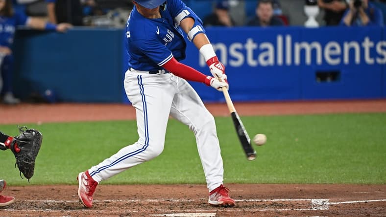 Oct 2, 2022; Toronto, Ontario, CAN; Toronto Blue Jays second base Whit Merrifield (1) hits a RBI single in the fourth inning against the Boston Red Sox at Rogers Centre. Mandatory Credit: Gerry Angus-USA TODAY Sports