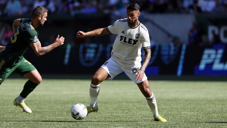 Oct 2, 2022; Portland, Oregon, USA; LAFC forward Denis Bouanga (99) controls the ball against Portland Timbers defender Dario Zuparic (13) during the first half at Providence Park. Mandatory Credit: Soobum Im-USA TODAY Sports
