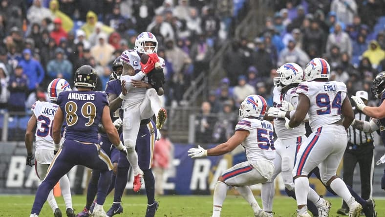 Oct 2, 2022; Baltimore, Maryland, USA; Buffalo Bills safety Jordan Poyer (21) leaps to secure a Baltimore Ravens quarterback Lamar Jackson (8) tipped pass during the third quarter at M&T Bank Stadium. Mandatory Credit: Tommy Gilligan-USA TODAY Sports