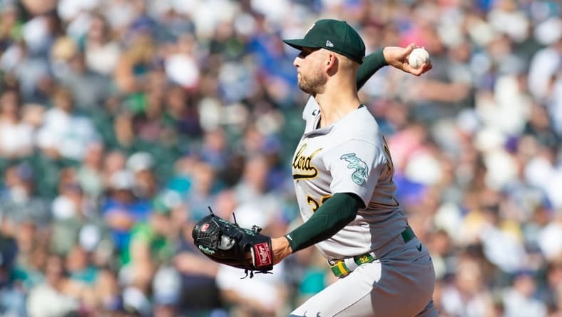 Oct 2, 2022; Seattle, Washington, USA; Oakland Athletics starting pitcher James Kaprielian (32) pitches to the Seattle Mariners during the first inning at T-Mobile Park. Mandatory Credit: Steven Bisig-USA TODAY Sports