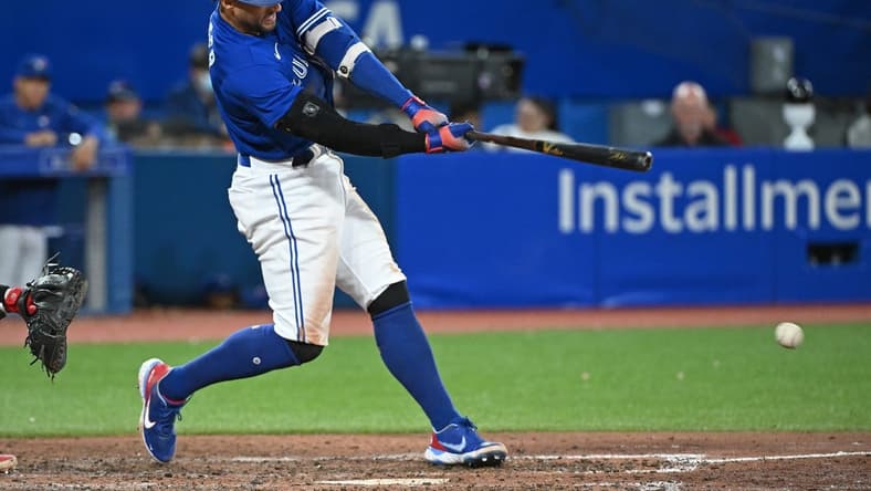 Oct 2, 2022; Toronto, Ontario, CAN; Toronto Blue Jays designated hitter George Springer (4) hits a RBI fielders choice single in the seventh inning against the Boston Red Sox at Rogers Centre. Mandatory Credit: Gerry Angus-USA TODAY Sports