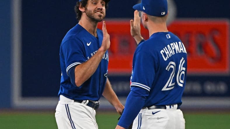 Oct 2, 2022; Toronto, Ontario, CAN; Toronto Blue Jays pitcher Jordan Romano (68) and third base Matt Chapman (26) celebrate the win against the Boston Red Sox at Rogers Centre. Mandatory Credit: Gerry Angus-USA TODAY Sports