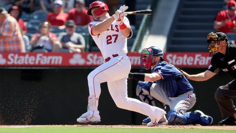 Oct 2, 2022; Anaheim, California, USA; Los Angeles Angels center fielder Mike Trout (27) hits a single during the first inning against the Texas Rangers at Angel Stadium. Mandatory Credit: Kiyoshi Mio-USA TODAY Sports