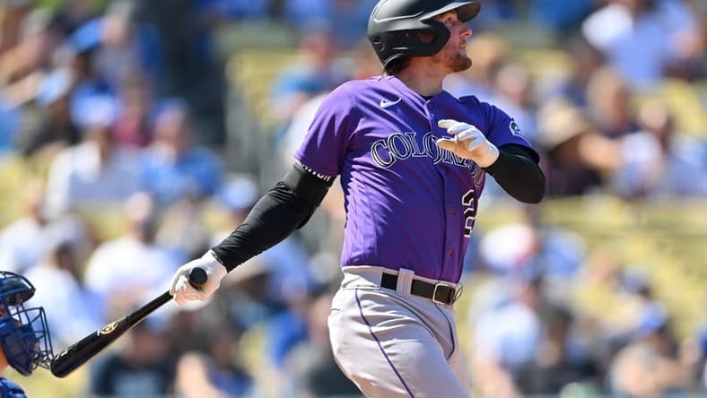 Oct 2, 2022; Los Angeles, California, USA; Colorado Rockies third baseman Ryan McMahon (24) hits a RBI double in the third inning against the Los Angeles Dodgers at Dodger Stadium. Mandatory Credit: Jayne Kamin-Oncea-USA TODAY Sports