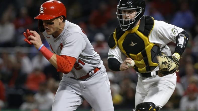 Oct 3, 2022; Pittsburgh, Pennsylvania, USA; St. Louis Cardinals right fielder Lars Nootbaar (left) is chased during a run down between third base and home plate by Pittsburgh Pirates catcher Jason Delay (right) during the fourth inning at PNC Park. Mandatory Credit: Charles LeClaire-USA TODAY Sports