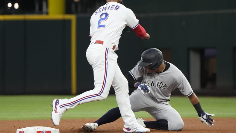 Oct 3, 2022; Arlington, Texas, USA; Texas Rangers second baseman Marcus Semien (2) forces out New York Yankees shortstop Oswald Peraza (91) during the fifth inning at Globe Life Field. Mandatory Credit: Jim Cowsert-USA TODAY Sports