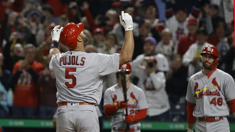 Oct 3, 2022; Pittsburgh, Pennsylvania, USA; St. Louis Cardinals designated hitter Albert Pujols (5) reacts as he crosses home plate on a two run home run against the Pittsburgh Pirates during the sixth inning at PNC Park. The home run was the 703rd of Pujols career and the two runs batted in moved him into second place on the all-time MLB RBI list with 2216 runs batted in. Mandatory Credit: Charles LeClaire-USA TODAY Sports