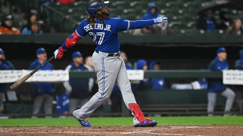 Oct 3, 2022; Baltimore, Maryland, USA; Toronto Blue Jays first baseman Vladimir Guerrero Jr. (27) hits a second inning solo home run against the Baltimore Orioles at Oriole Park at Camden Yards. Mandatory Credit: Tommy Gilligan-USA TODAY Sports