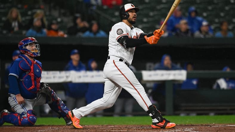 Oct 3, 2022; Baltimore, Maryland, USA; Baltimore Orioles right fielder Anthony Santander (25) hits  sacrifice fly to right field scoring shortstop Jorge Mateo (3) in the third inning against the Toronto Blue Jays  at Oriole Park at Camden Yards. Mandatory Credit: Tommy Gilligan-USA TODAY Sports