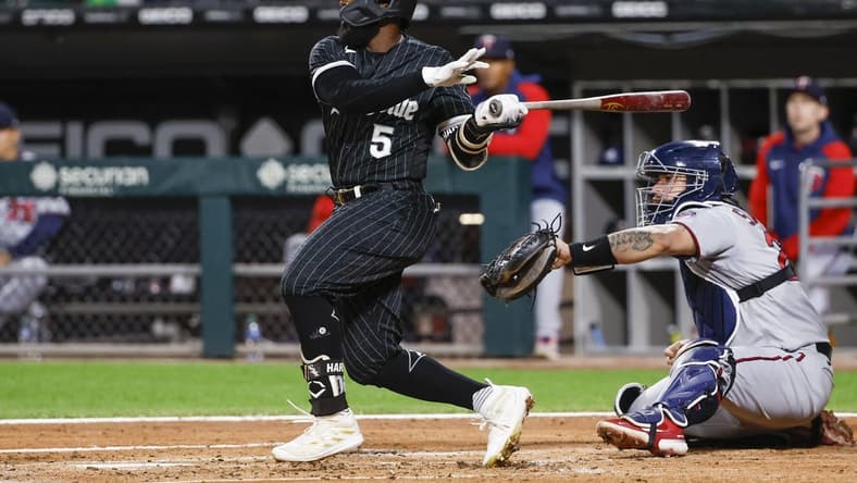 Oct 3, 2022; Chicago, Illinois, USA; Chicago White Sox second baseman Josh Harrison (5) hits a two-run home run against the Minnesota Twins during the second inning at Guaranteed Rate Field. Mandatory Credit: Kamil Krzaczynski-USA TODAY Sports