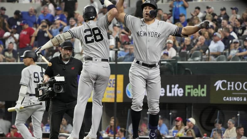 Oct 3, 2022; Arlington, Texas, USA; New York Yankees designated hitter Giancarlo Stanton (right) celebrates his home run with third baseman Josh Donaldson (28) against the Texas Rangers during the eighth inning at Globe Life Field. The Yankees won 3-1. Mandatory Credit: Jim Cowsert-USA TODAY Sports