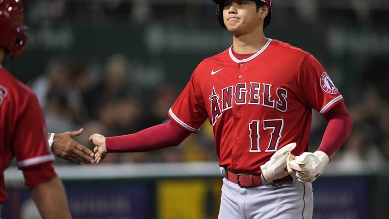 Oct 3, 2022; Oakland, California, USA; Los Angeles Angels designated hitter Shohei Ohtani (17) receives congratulations after scoring a run against the Oakland Athletics during the fourth inning at RingCentral Coliseum. Mandatory Credit: Darren Yamashita-USA TODAY Sports