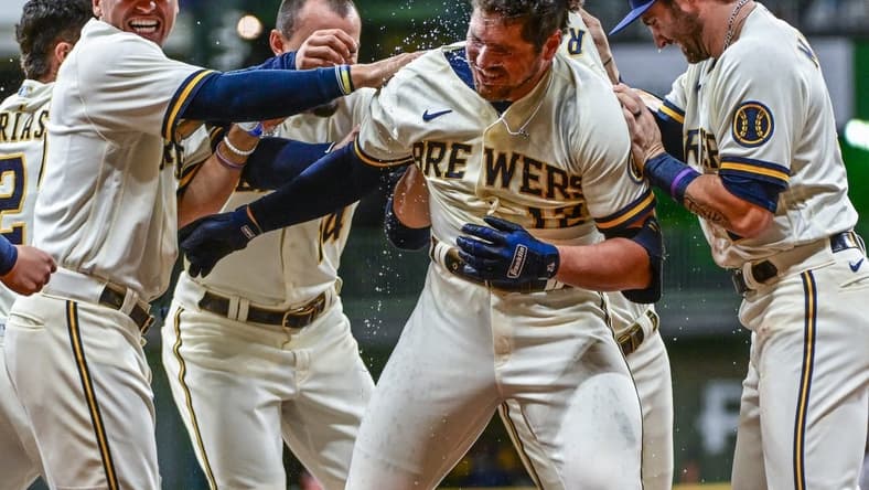 Oct 3, 2022; Milwaukee, Wisconsin, USA; Milwaukee Brewers right fielder Hunter Renfroe (12) celebrates after driving in the winning run in the tenth inning against the Arizona Diamondbacks at American Family Field. Mandatory Credit: Benny Sieu-USA TODAY Sports