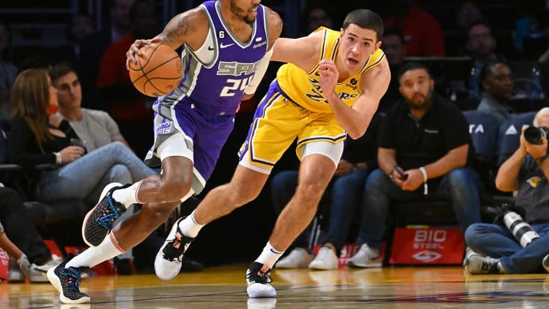 Oct 3, 2022; Los Angeles, California, USA; Sacramento Kings forward Kent Bazemore (24) drives to the basket as he is defended by Los Angeles Lakers forward Cole Swider (20) in the second half at Crypto.com Arena. Mandatory Credit: Jayne Kamin-Oncea-USA TODAY Sports