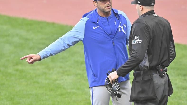 Oct 4, 2022; Cleveland, Ohio, USA; Kansas City Royals manager Mike Matheny (22) talks with home plate umpire Nic Lentz (59) in the first inning against the Cleveland Guardians at Progressive Field. Mandatory Credit: David Richard-USA TODAY Sports