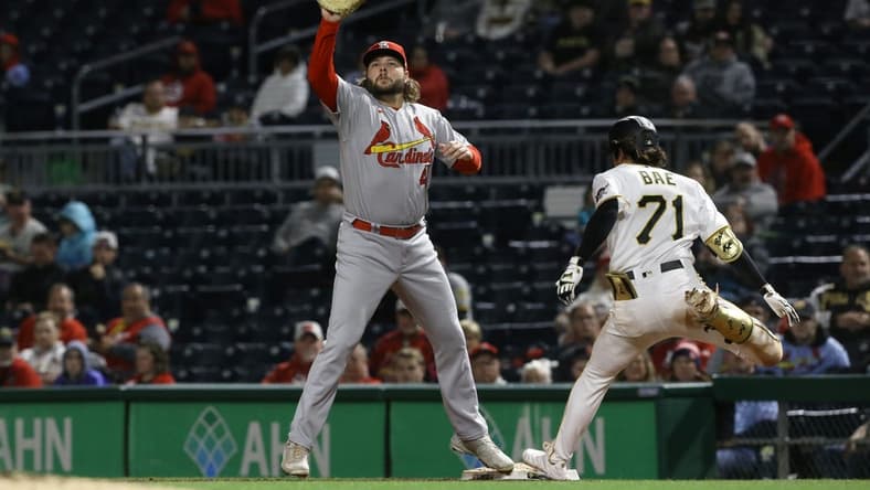 Oct 4, 2022; Pittsburgh, Pennsylvania, USA; Pittsburgh Pirates center fielder Ji Hwan Bae (71) beats the throw to St. Louis Cardinals first baseman Alec Burleson (41) for an RBI single during the third inning at PNC Park. Mandatory Credit: Charles LeClaire-USA TODAY Sports