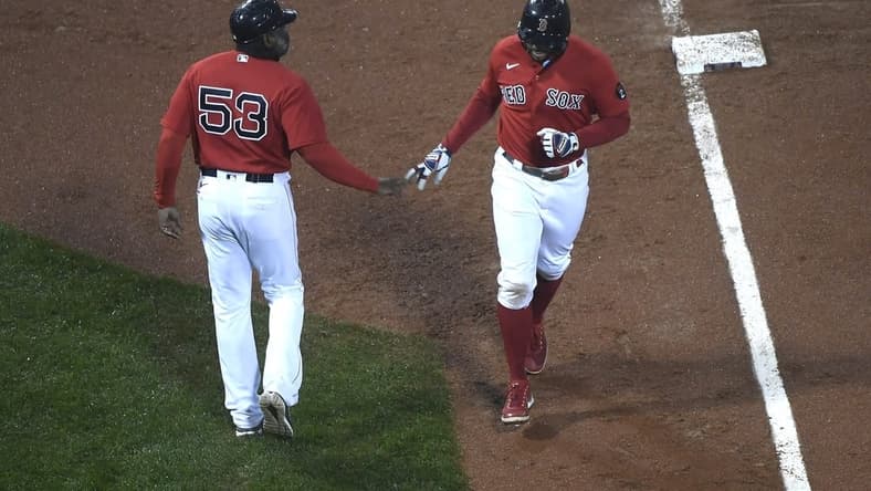 Oct 4, 2022; Boston, Massachusetts, USA; Boston Red Sox shortstop Xander Bogaerts (2) is congratulated by third base coach Carlos Febles (53) after hitting a grand slam during the fifth inning at Fenway Park. Mandatory Credit: Bob DeChiara-USA TODAY Sports