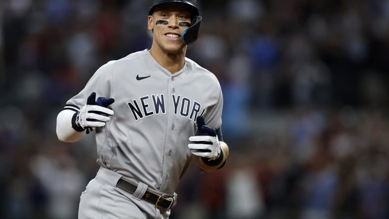 Oct 4, 2022; Arlington, Texas, USA; New York Yankees right fielder Aaron Judge (99) rounds the bases after hitting home run #62 to break the American League home run record in the first inning against the Texas Rangers at Globe Life Field. Mandatory Credit: Tim Heitman-USA TODAY Sports
