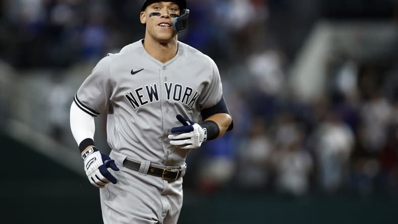 Oct 4, 2022; Arlington, Texas, USA; New York Yankees right fielder Aaron Judge (99) rounds the bases after hitting home run #62 to break the American League home run record in the first inning against the Texas Rangers at Globe Life Field. Mandatory Credit: Tim Heitman-USA TODAY Sports